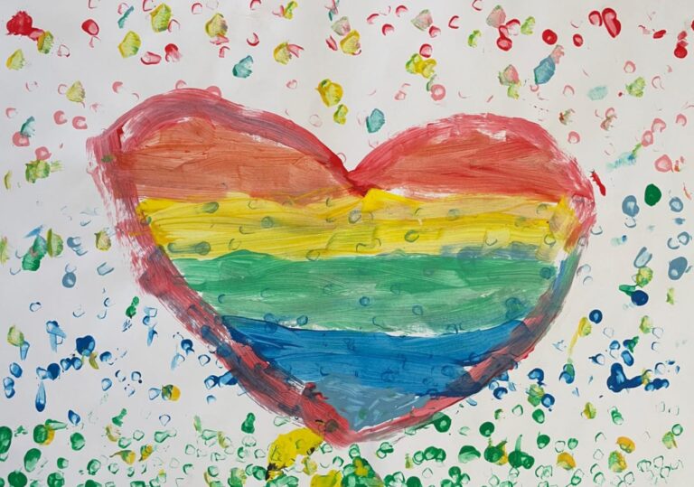 Cuore dipinto a mano con strisce orizzontali nei colori dell'arcobaleno e sfondo di puntini colorati, realizzato in stile tempera da persone bambine.